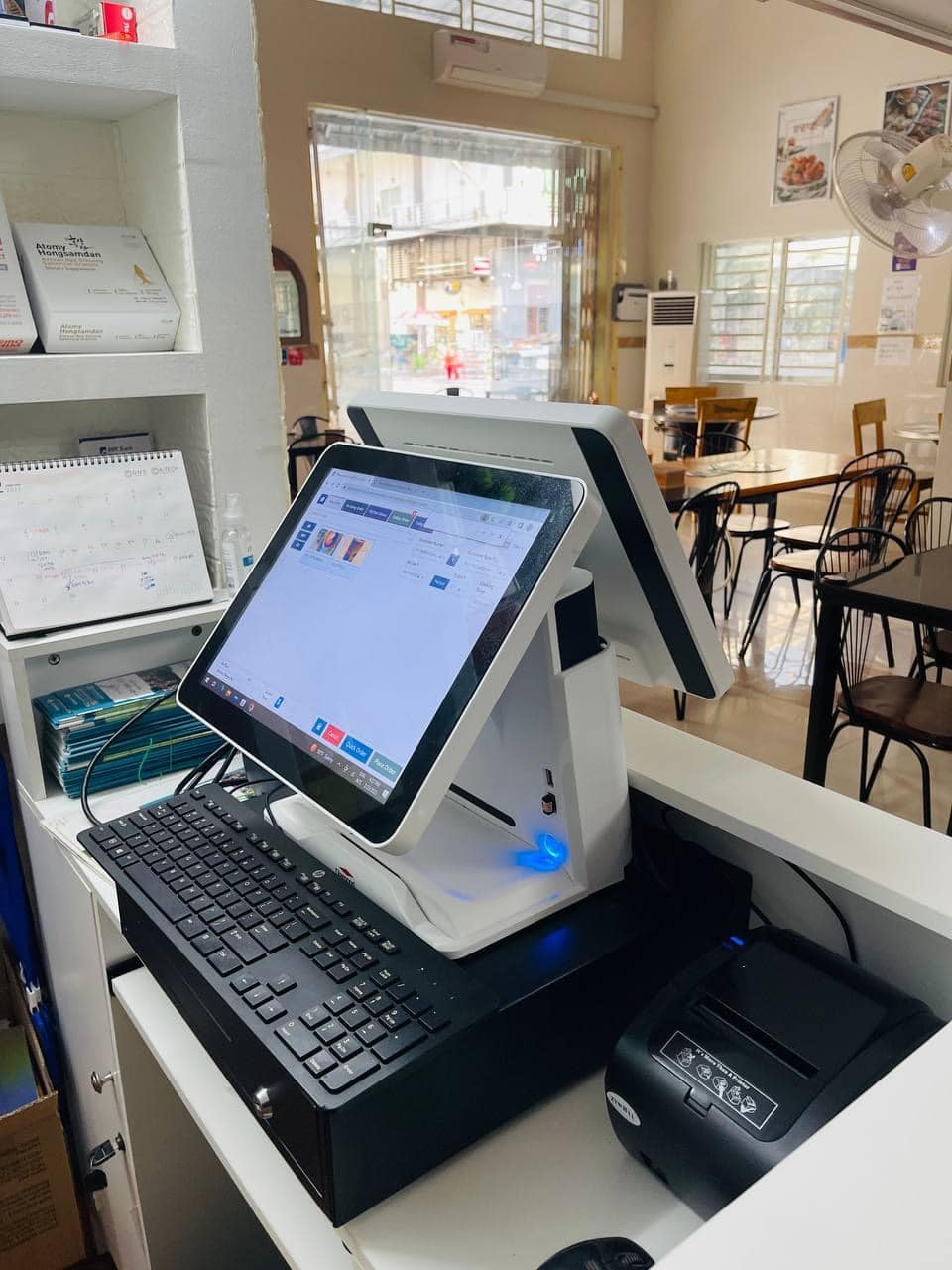 Dual-screen POS terminal, cash drawer and receipt printer ready for service