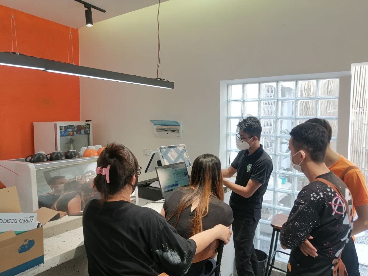 Staff training session in front of a POS screen