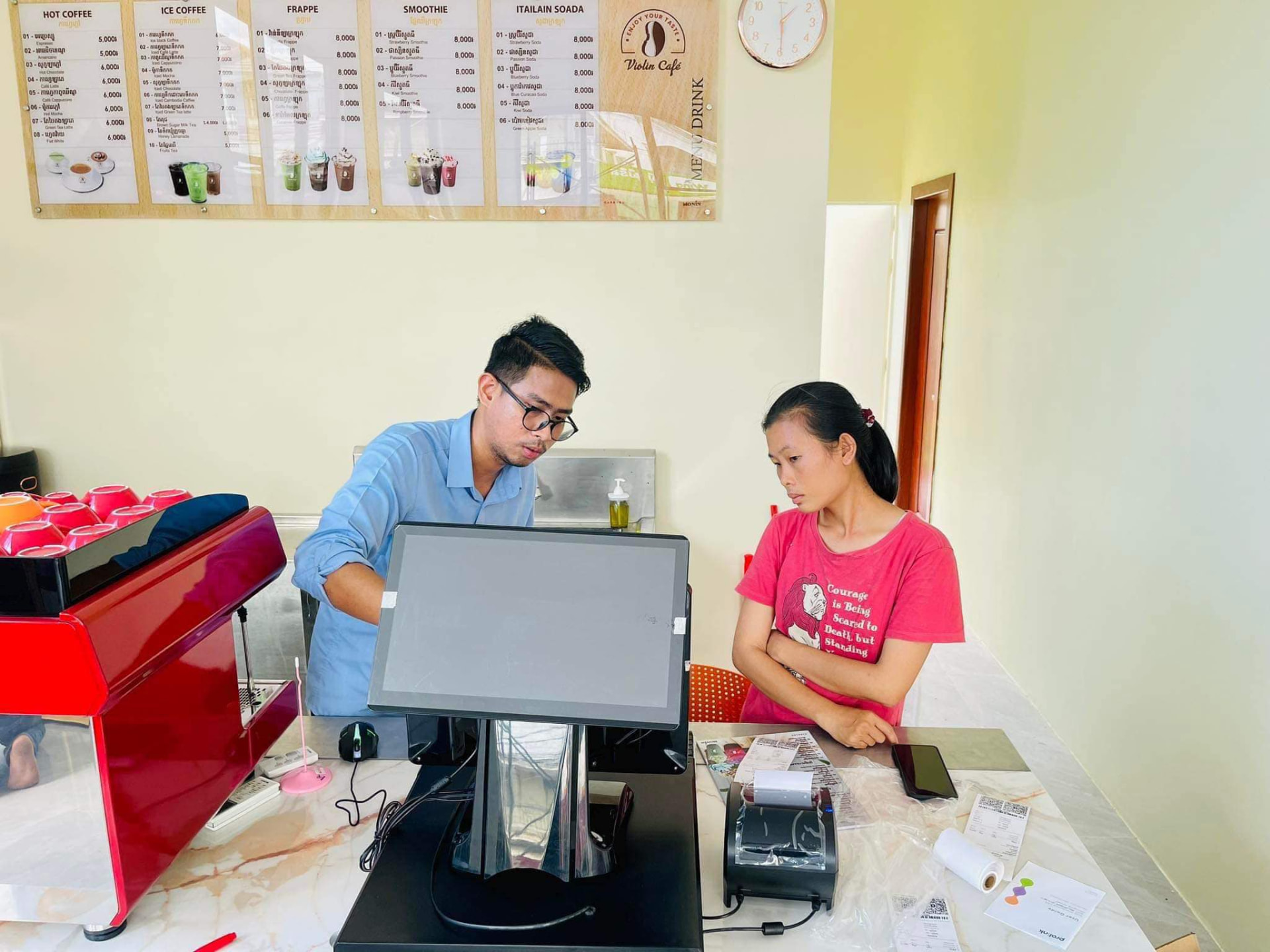 Cashier learning the menu screen with a NOKOR BIZ consultant
