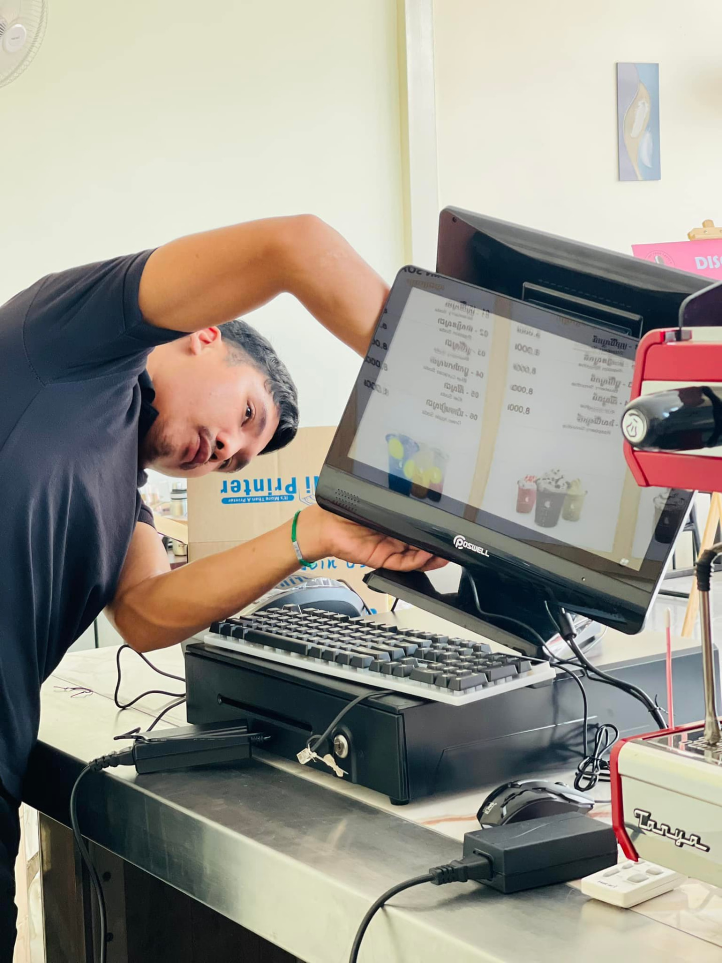 Engineer mounting a customer-facing display on a POS stand